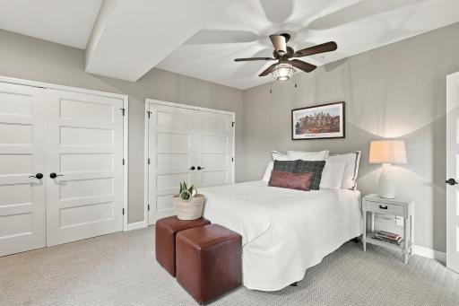 Lower level bedroom with two double door closets, ceiling fan & egress window