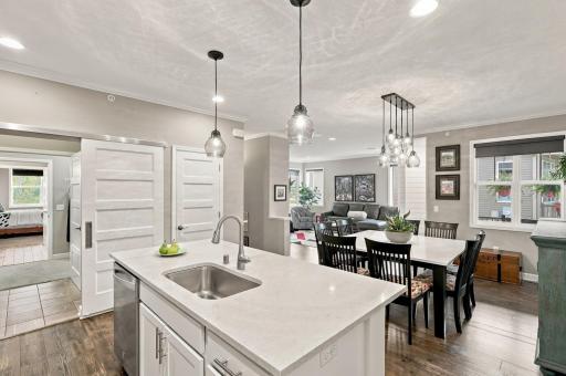Sliding doors close off the laundry area & the pantry closet keeps the kitchen countertops uncluttered