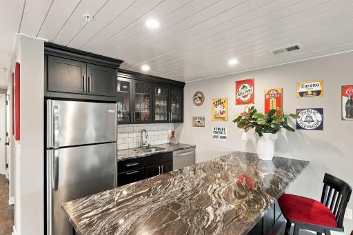 You're going to love this fully equipped wetbar with full size appliances & stunning granite seating bar