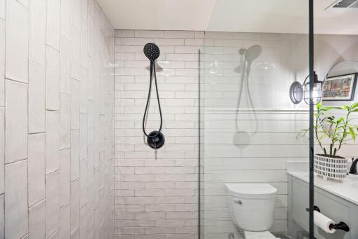 Bevealed horizontal & vertical rubway tile elevates this frameless walkin shower.