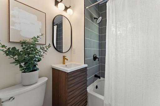Brand new full bathroom with deep soaking tub, rainfall shower head, and shower tile