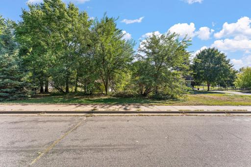 Home is graciously covered by mature trees on a corner lot