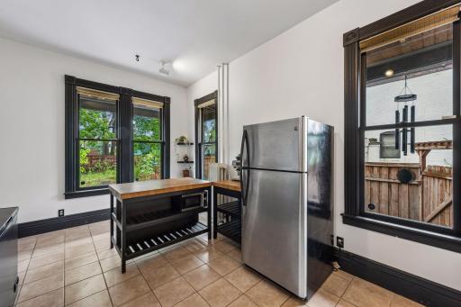 The kitchen overlooks the lush backyard full of native pollinator plants.