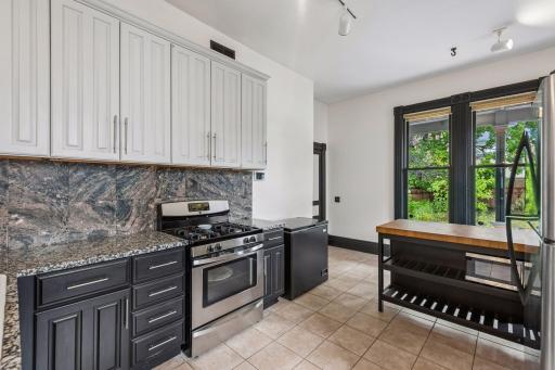 The kitchen overlooks the lush backyard full of native pollinator plants.