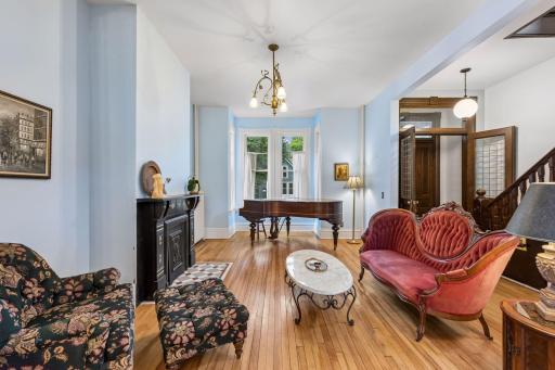 The living room is full of natural light and a bay window.