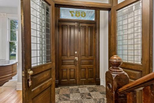 Upon entering you're greeted with handsome woodwork and original double doors.