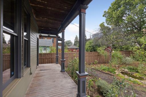 Through the back door is a wrap around porch that overlooks the native pollinator garden.