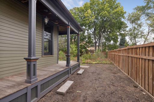 Side yard is a blank slate waiting for your ideas! A double gate leads to this area, and could be used as a parking pad.