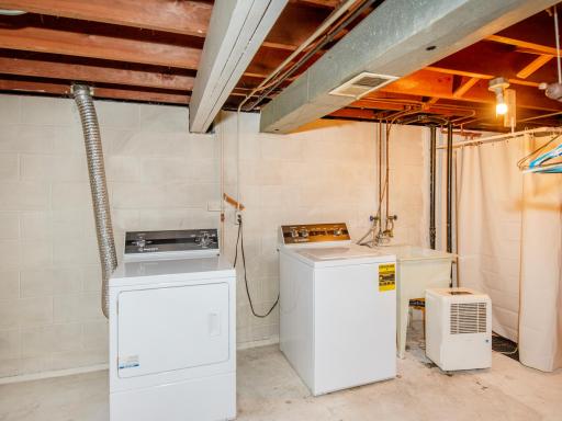 Lower level laundry area with utility sink.