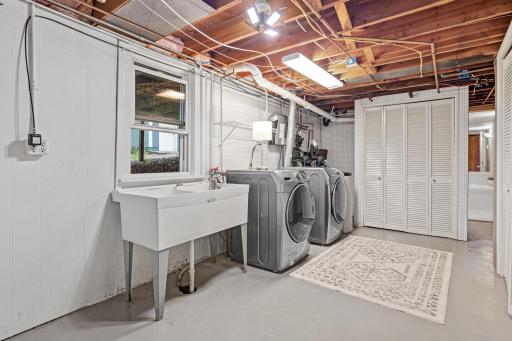 Lower level laundry and utility room . Large double sink for convenience and window to add more light.