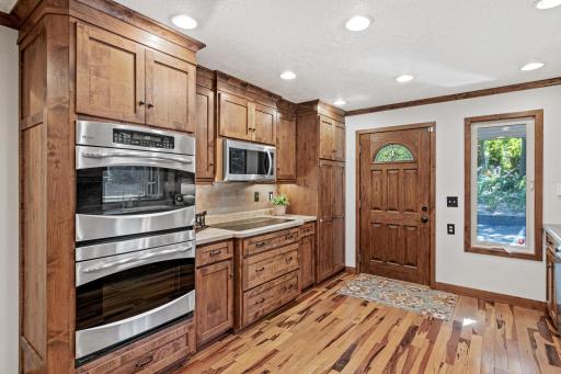 Beautifully appointed with warm pecan flooring, custom Alder cabinetry and stainless-steel appliances, this inviting kitchen blends style with everyday functionality.