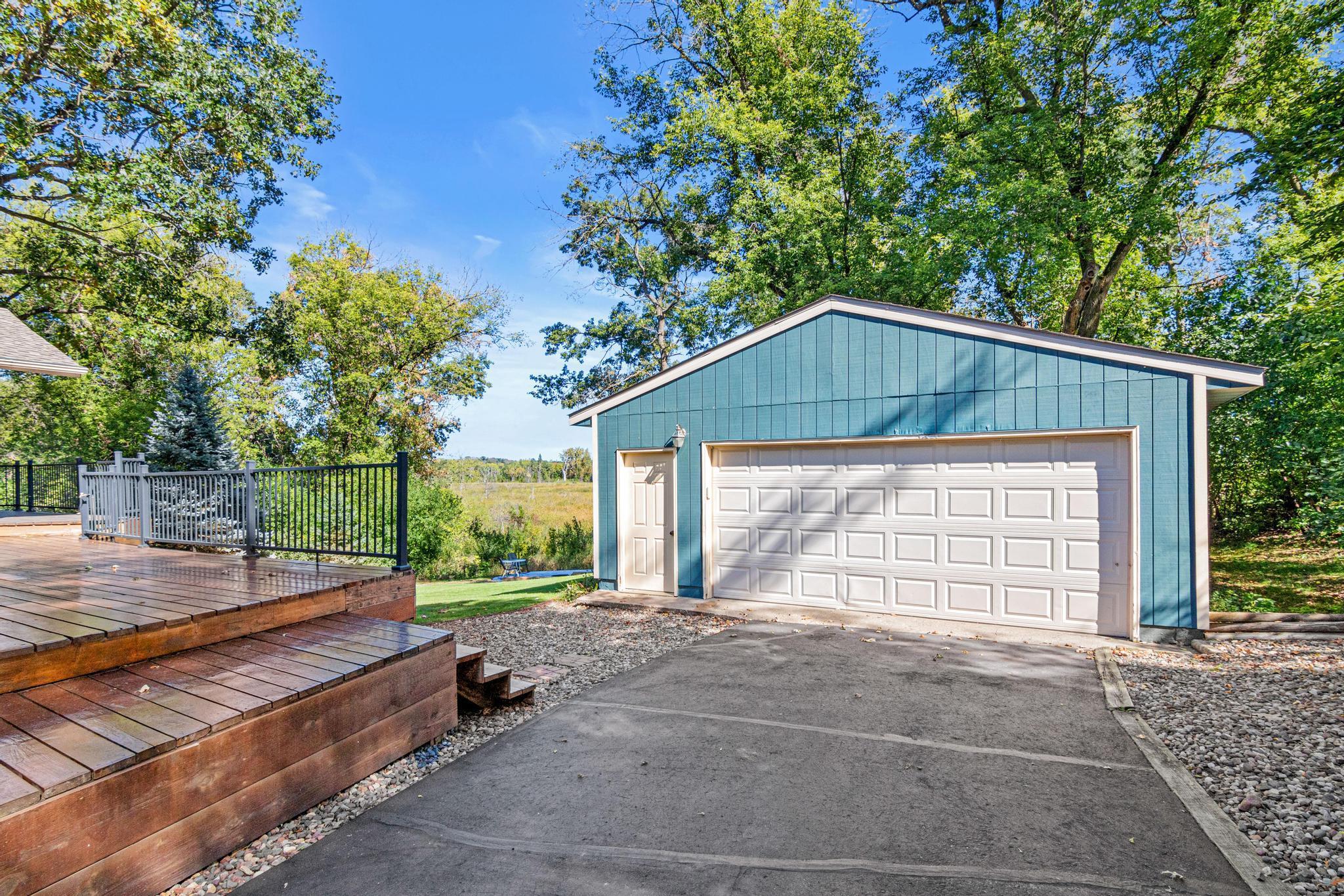 Detached 2-car garage with plenty of storage space and epoxy flooring.