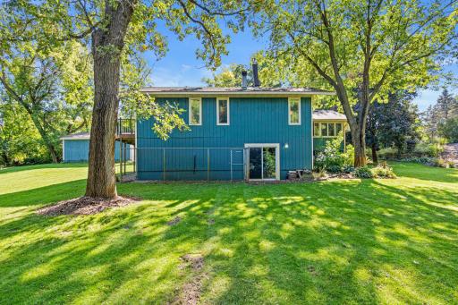 Side yard has access to the lower level and also has an outside, fenced dog kennel.