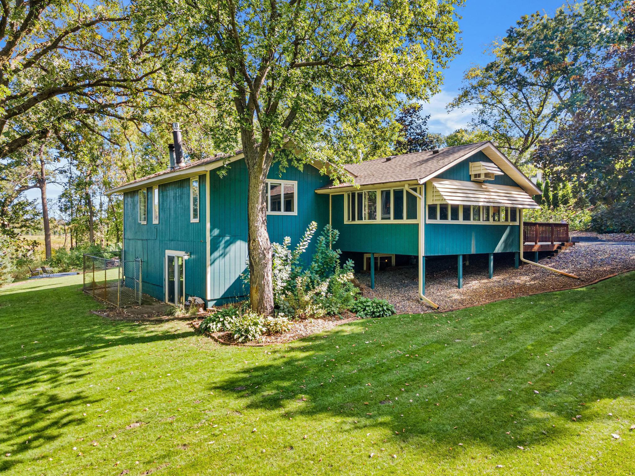 Gorgeous perennials, beautiful green grass and trees create the perfect retreat to call home.