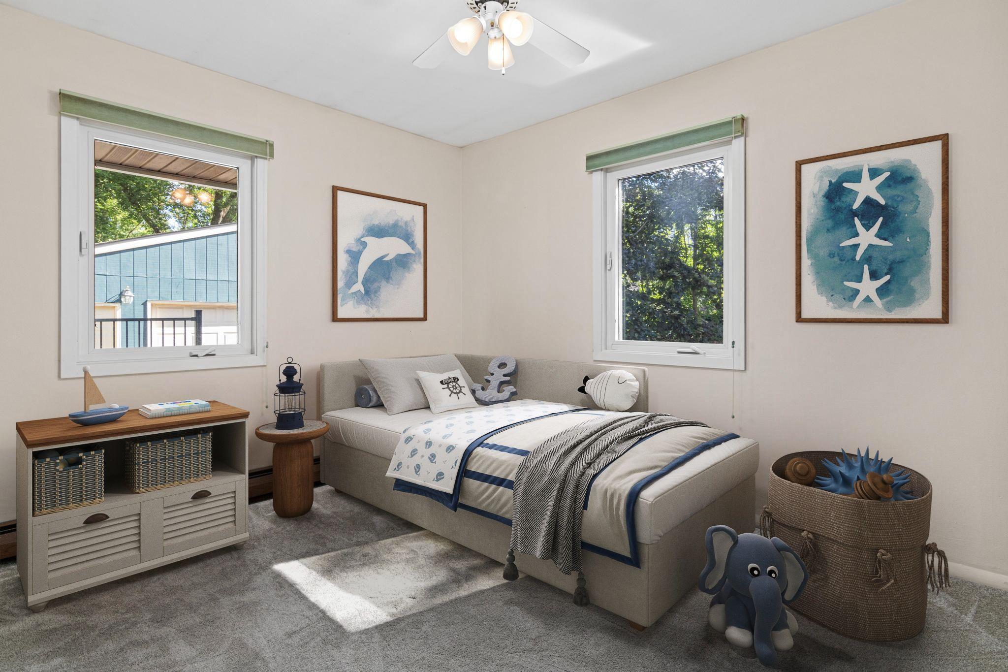 One of three bedrooms on the main level, overlooking the south and east side of the yard. Visually staged.