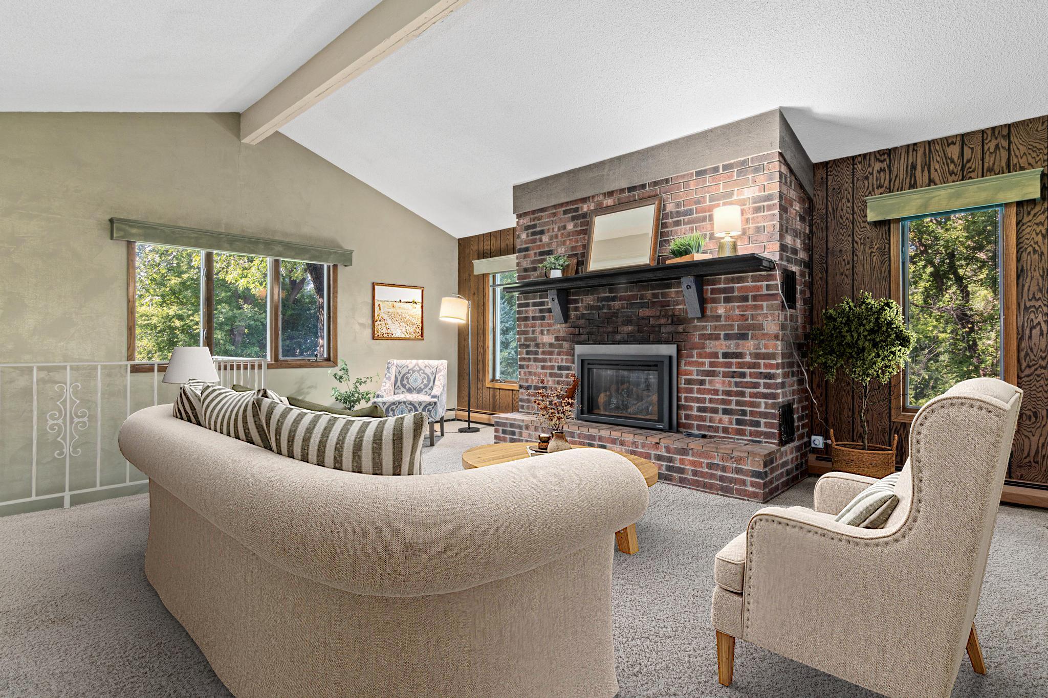 A warm and inviting living room features a cozy gas fireplace, creating the perfect gathering space for relaxing evenings at home. Visually staged.