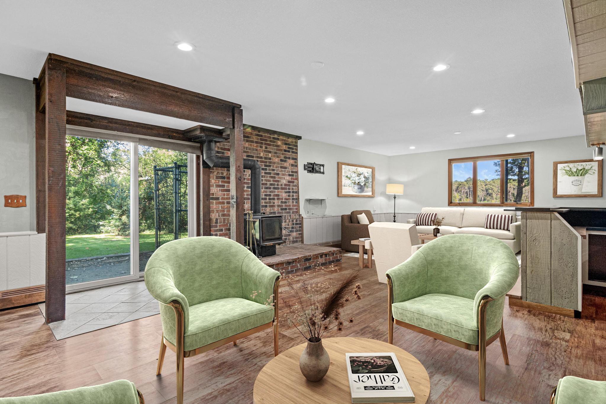 Walk out lower level is the perfect place to watch the big game or your favorite movie. The wood-burning fireplace creates a warm focal point and adds to the cozy atmosphere of this fun space. Virtually staged.