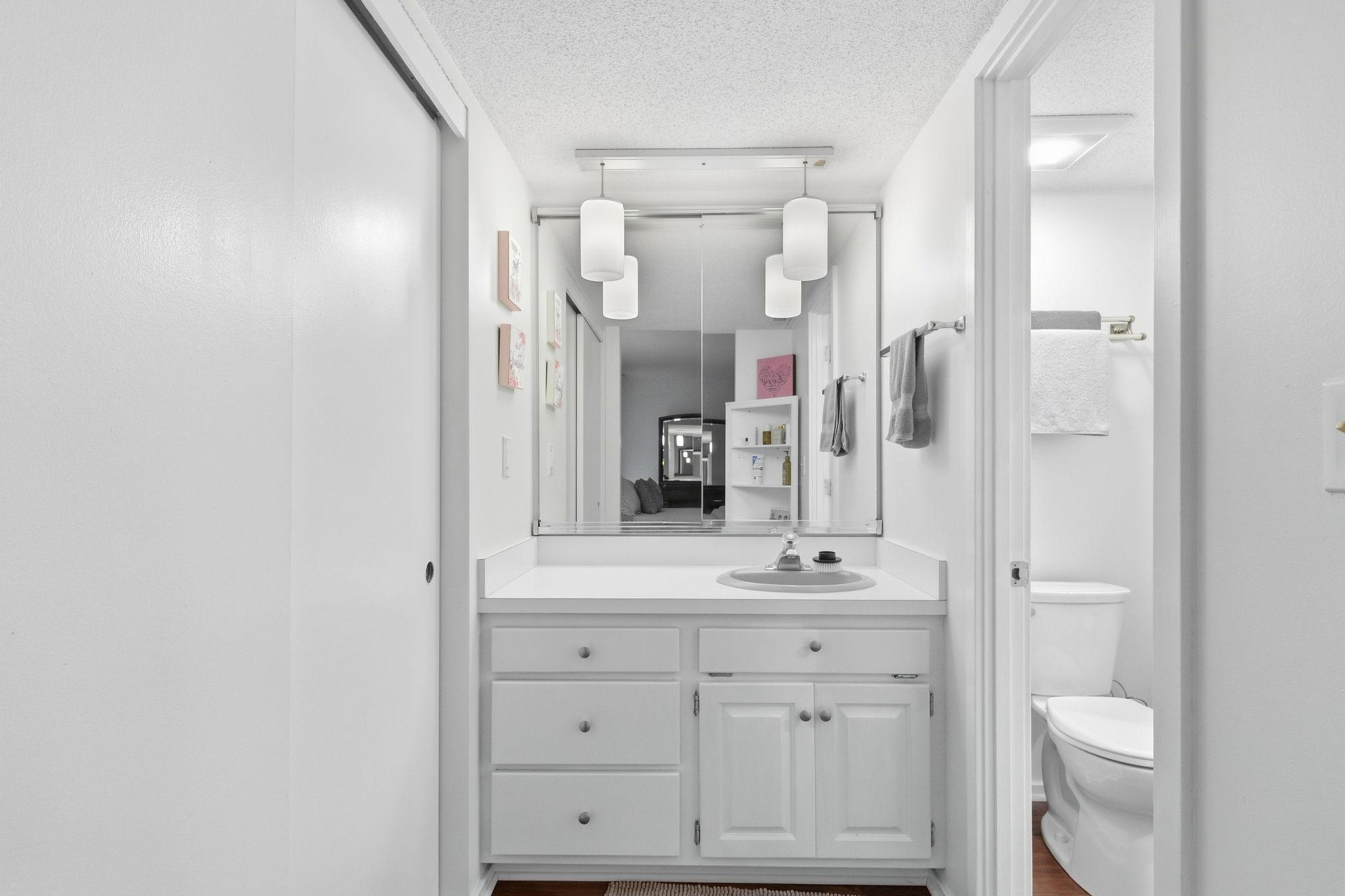 Great private sink area with a linen closet.