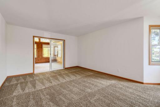 Spacious upper level living room with new carpet, fresh paint and access to the four season porch.