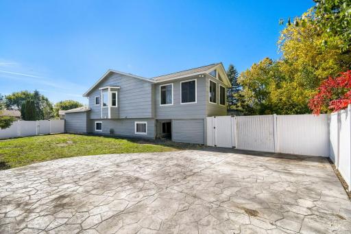 Fully fenced back yard with privacy fence and large stamped concrete patio.