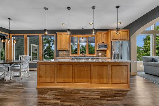 Step Into The Sun-Drenched Gourmet Kitchen That Will Not Disappoint! Custom Cabinetry, Oversized Granite Center Island, And A Spacious Layout Tailored For Effortless Year-Round Entertaining, This Light-Filled Space Offers Breathtaking Lake Views!