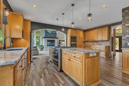 The kitchen offers sweeping views into the vaulted living room, creating yet another bright, welcoming space to gather, relax and enjoy the lake views!
