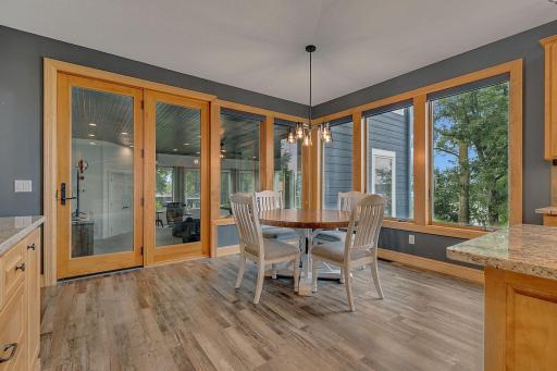 Dining Room Overlooking The Massive Main Floor Family/Sun Room. Wrapped In Windows And Bathed In Natural Light And Amazing Lakeshore Views Makes This the Place To Be!