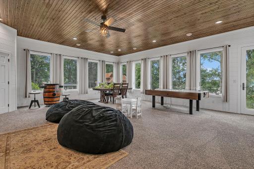 Flooded With Natural Light Through Surround Windows, This Expansive Main-Floor Sunroom Offers An Inviting, Sun-Soaked Space Built For Hosting And Everyday Gathering