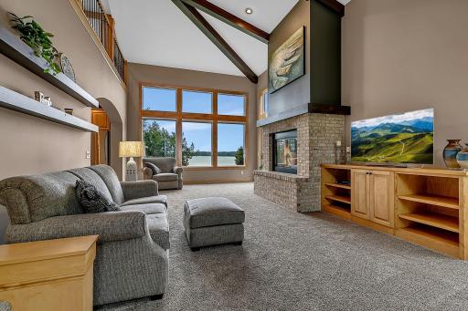 With Soaring Vaulted Ceilings And Open Lake Views, The Living Room Flows Seamlessly From The Kitchen To Offer An Additional Gathering Space!