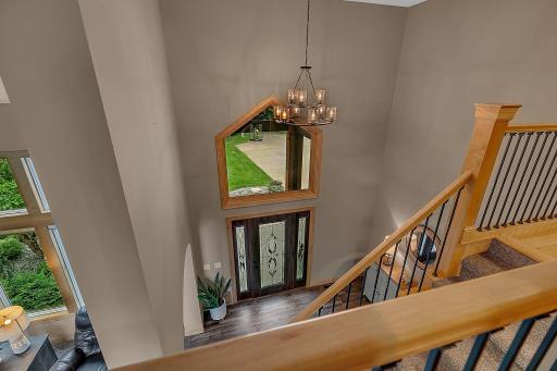 A dramatic, soaring entryway opens into the home, offering an inviting sightline that immediately sets a tone of grandeur and warmth!