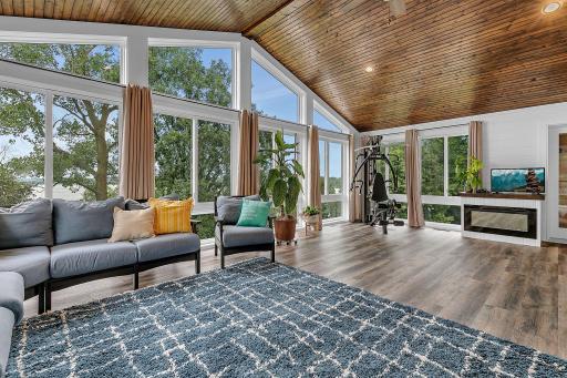 Prepare to be dazzled by this breathtaking 48' x 25' sunroom. Soaring floor-to-ceiling windows flood the space with natural light & frame panoramic outdoor views, while a rich knotty pine ceiling adds warmth and architectural character!!