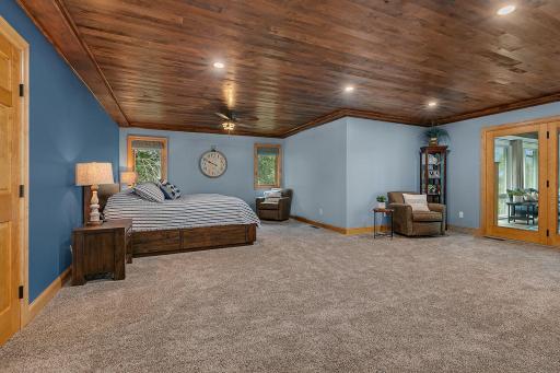 Very Spacious Primary Bedroom, Rich Knotty Pine Adds Warmth French Doors Draw You Into The Beautiful Sunroom Overlooking The Lake!