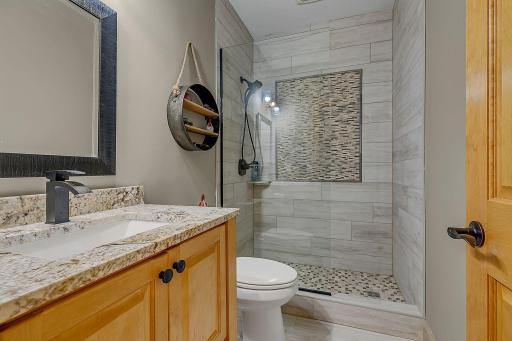 Lower Level Bath Complete With Custom Stone, Granite Tops, Step In Shower!!