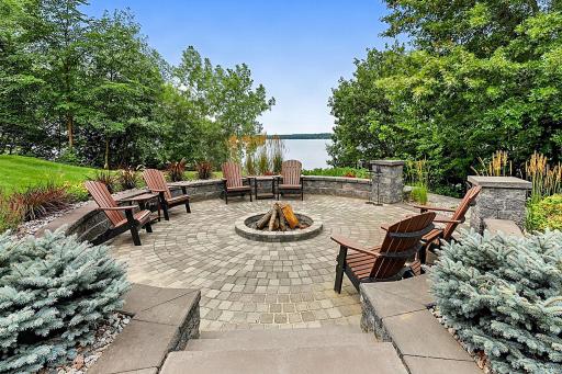 Designed For Effortless Hosting, The Expansive Outdoor Patio And Custom Fire Pit Complete With Built In Outdoor Lighting Overlooks The Water, Offering Breathtaking Panoramic Views Of The Entire Lake!