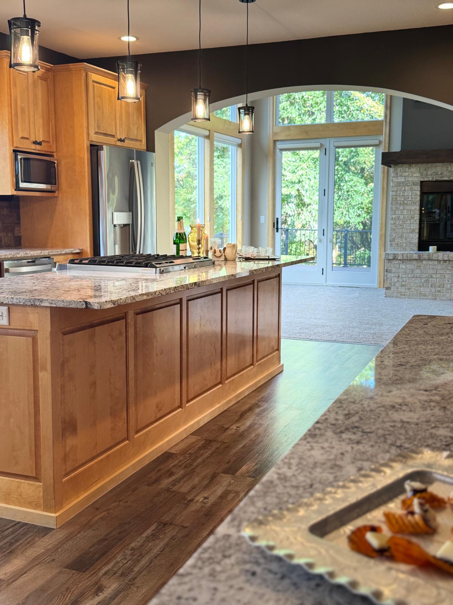 Open kitchen seamlessly overlooks dining area adorned with striking architectural beams & elegant arches. From here, step outside to a newly constructed composite deck & outdoor seating, offering a smooth indoor-outdoor flow design!