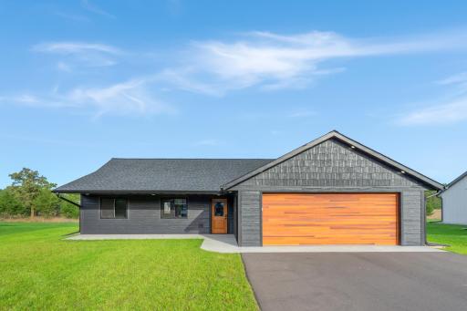 Exterior features a finished yard with sprinkler system