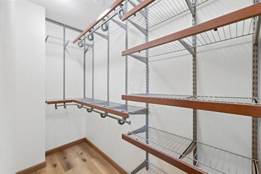 Huge walk in primary closet with organization system