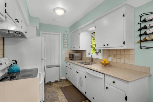 Large window above sink offers incredible views to backyard.