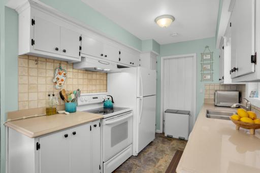 Updated enameled kitchen, great amount of counter space in Silestone and updated hardware.. Back door is access to third bedroom if desired.