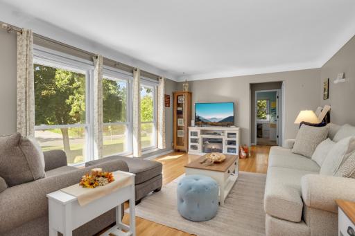 Light and bright living room offering cove ceilings and wall of windows