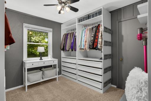 Main floor third bedroom currently used as walk in closet. All shelving is freestanding. Door to kitchen is behind this wall unit