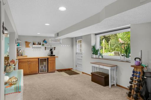 Corner gas fireplace, dry bar area and easy access to outside. Wonderful added space for any home office.