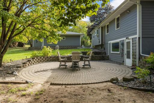 Fantastic paver patio and retaining wall with steps down from garage area.