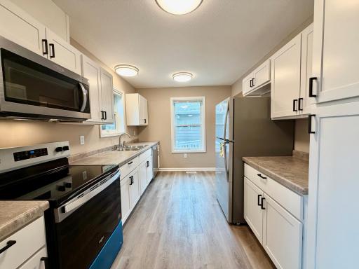 Great kitchen, stainless steel appliances, back door to the home just around the corner.