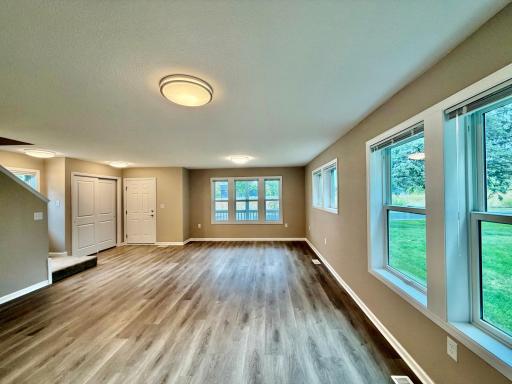 Large living room, plenty of natural light through the windows.