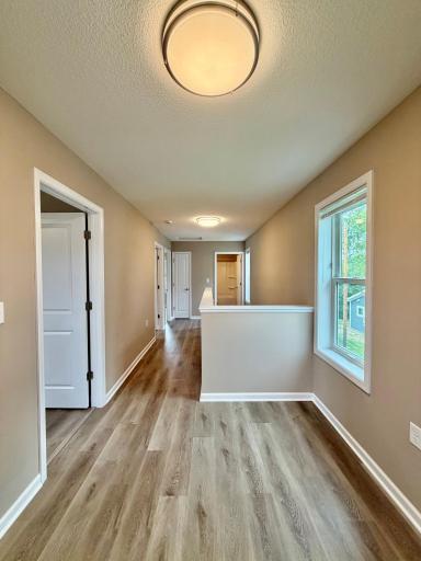 Upstairs loft area, with three bedrooms and a full bath upstairs.