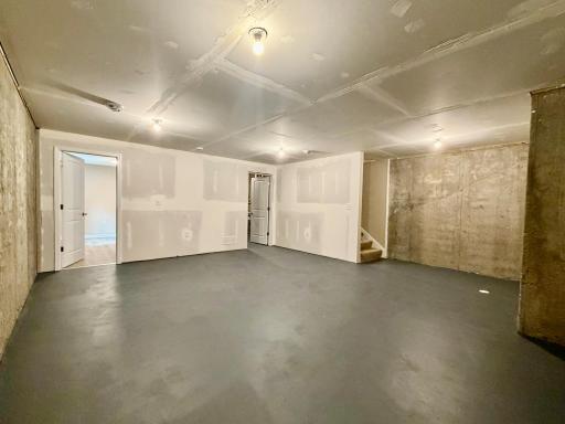 Huge unfinished room in lower level... future family room?