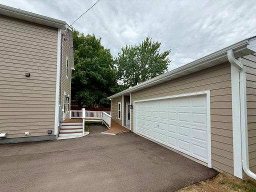 Handicapped accessible ramp out back kitchen door to ADU and driveway.