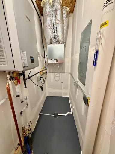 Mechanical room showing tankless hot water heater, air exchanger and radon mitigation system.