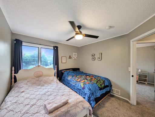 Features a bright window and a ceiling fan!